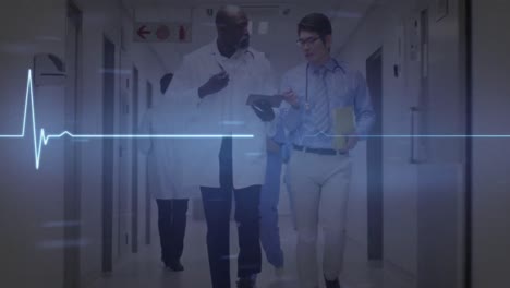 Animation-of-heart-rate-monitor-over-two-diverse-male-doctors-discussing-at-hospital