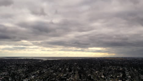 un lapso de tiempo aéreo sobre un barrio suburbano por la noche, justo antes del atardecer