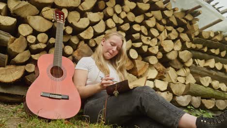 beautiful country girl songwriter composes lyrics rustic log scene