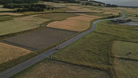 cars, agricultural tractor drive at les angles france aerial view road around green rural fields