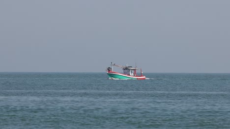 a single boat moves steadily over tranquil waters.