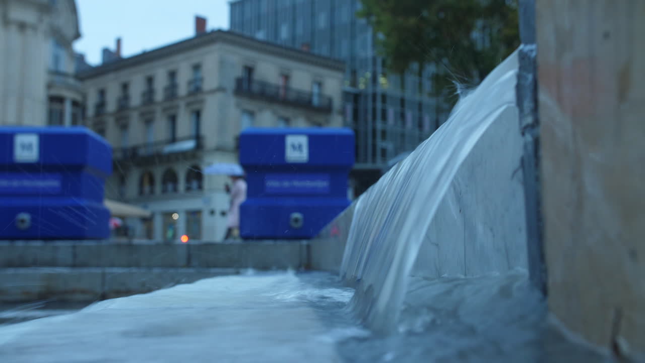 waterfall on stairs in Montpellier heavy rainy day wet pavement comedy square