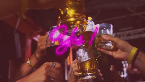 animation of yes pink neon text over diverse friends drinking making toast in bar