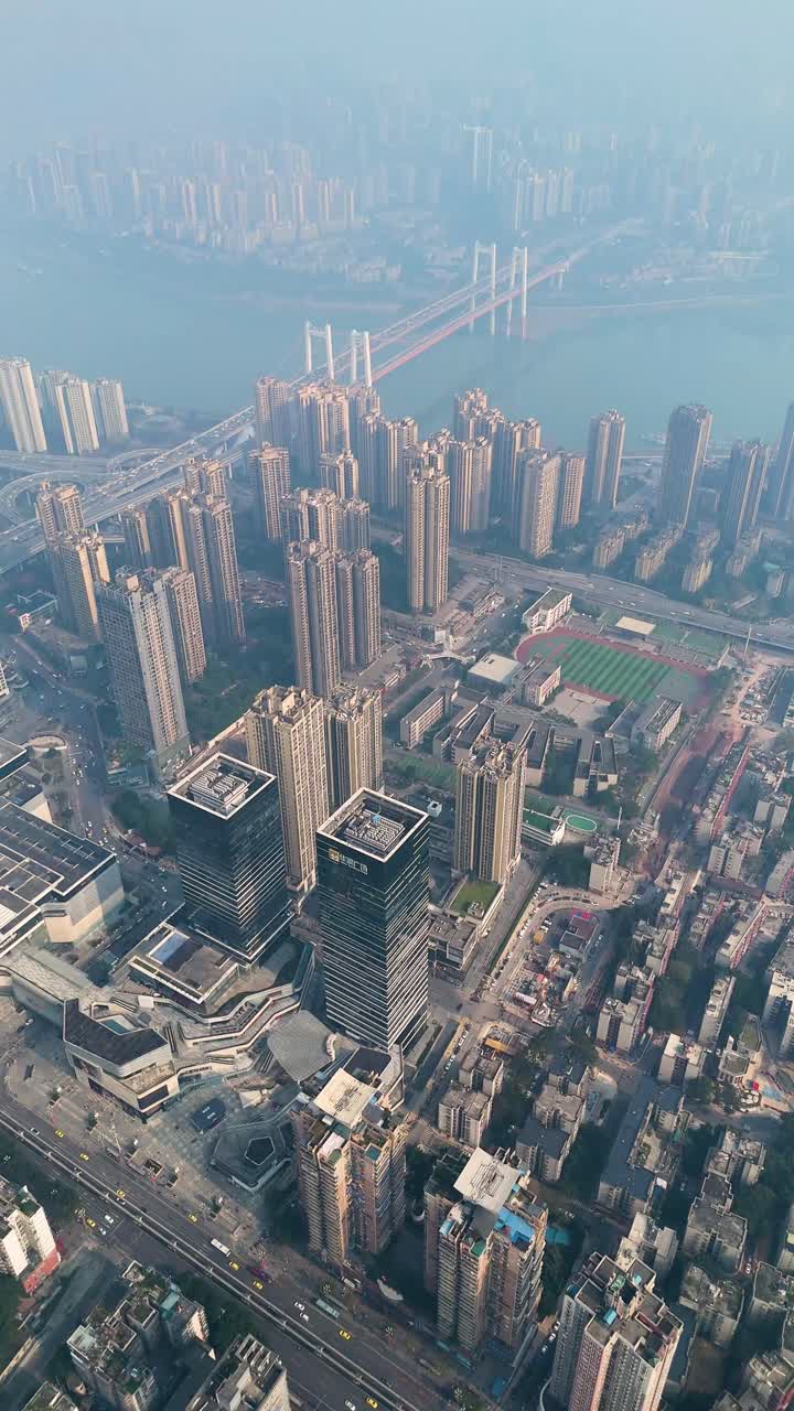 Vertical aerial: Chongqing cityscape with extreme pollution during the day in Yuzhong District, China, establishing drone shot