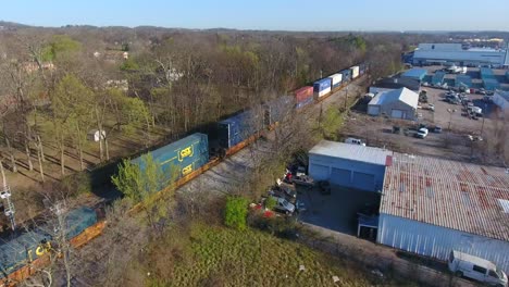 4k aerial freight train box cars flyover nashville tennessee tracks following circle right