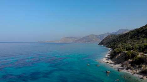 beautiful seaside panorama with rocky mountains washed by blue turquoise ionian sea