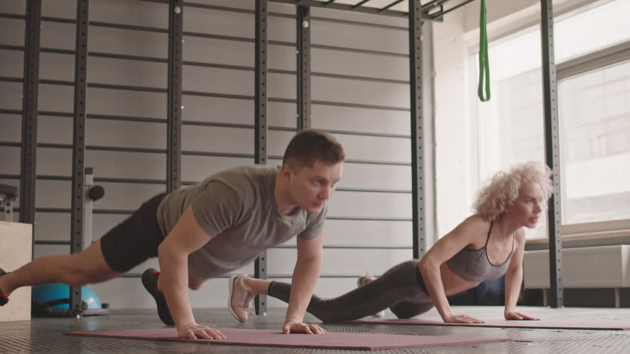 Woman and Man Doing Burpees