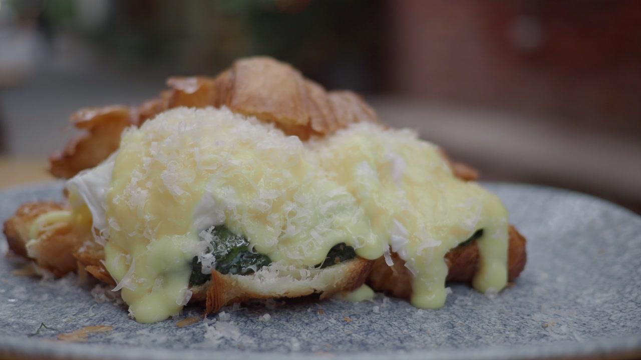 Delicious Croissant with Poached Eggs, Spinach, and Hollandaise Sauce