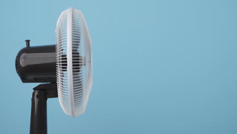 electric fan against a blue background