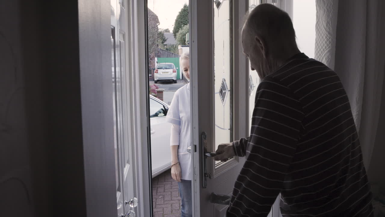 Elderly Man Opening Door with Nurse
