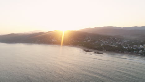 sunrise aerial over sayulita mexican pacific coast with sun flare, 4k