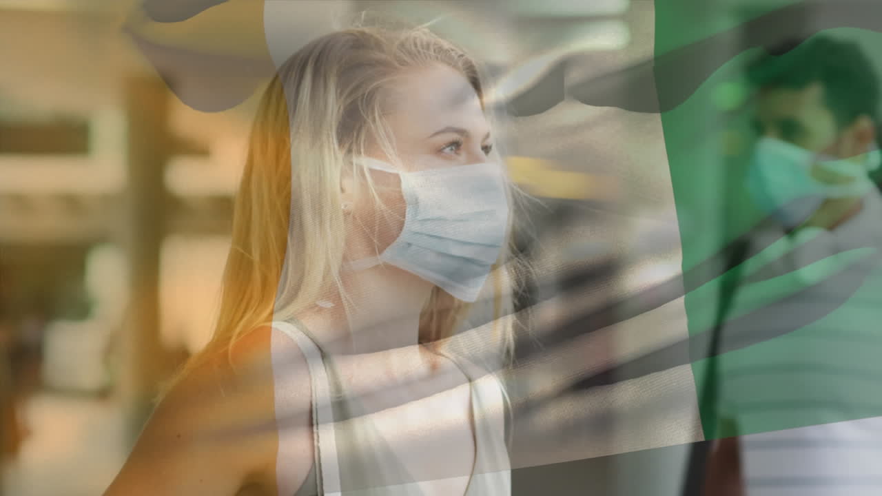 코로나19 전염병 기간 동안 마스크를 쓰고 있는 여성이 코트디부아르의 국기를 흔들고 있는 애니메이션