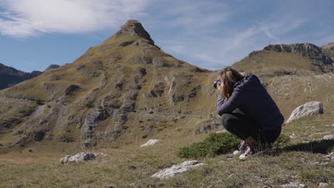 female photographer takes photos of the scenic peaks in durmitor national park