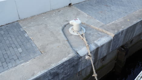 bollard with rope on a concrete dock