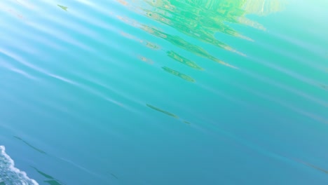 lake thun with clear turquoise rippled waters near spiez, switzerland, boat pov