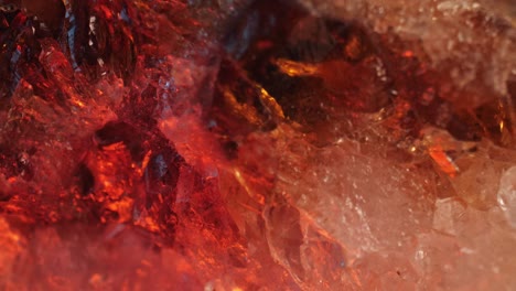 intricate details of the surface of a citrine golden quartz studio-lit against a black background