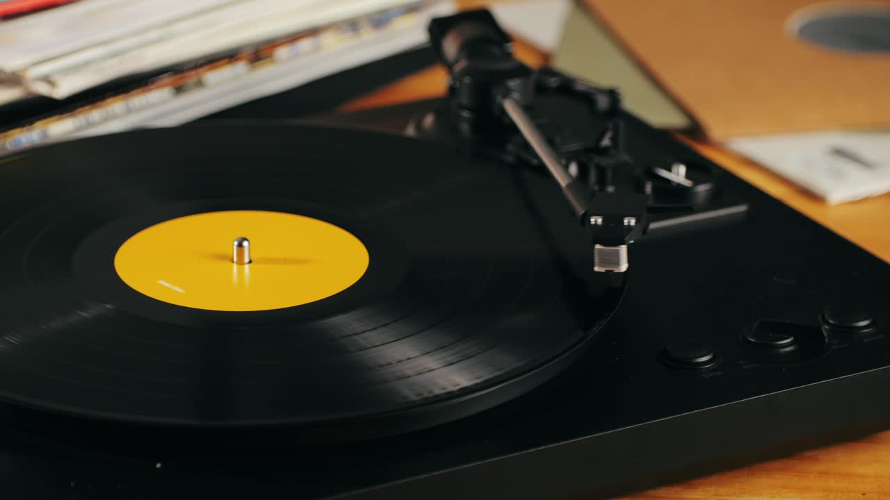 Retro Vinyl record player playing music, close-up macro shot of vintage LP disc old phonograph spinning. Retro music player.