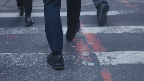 pedestrians cross a city street