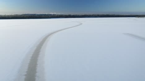 forward moving aerial view over frozen lake following natural line patterns on ice