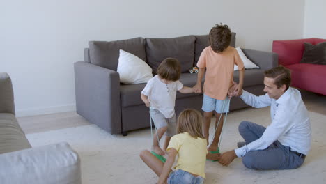 cute kids playing with toy dinosaur footprints