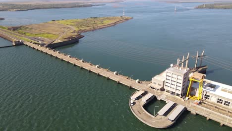 Panoramic-view-capturing-the-expansive-Yacyretá-Dam,-a-monumental-structure-straddling-the-border-between-Argentina-and-Paraguay,-serving-as-a-vital-source-of-clean-energy-and-regional-development