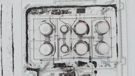 the drone flies around the oil storage tank, oil and gas reserves of russia. oil and gas industry in the world economy flying over tanks in winter during a price increase crisis. oil and gas reserves.