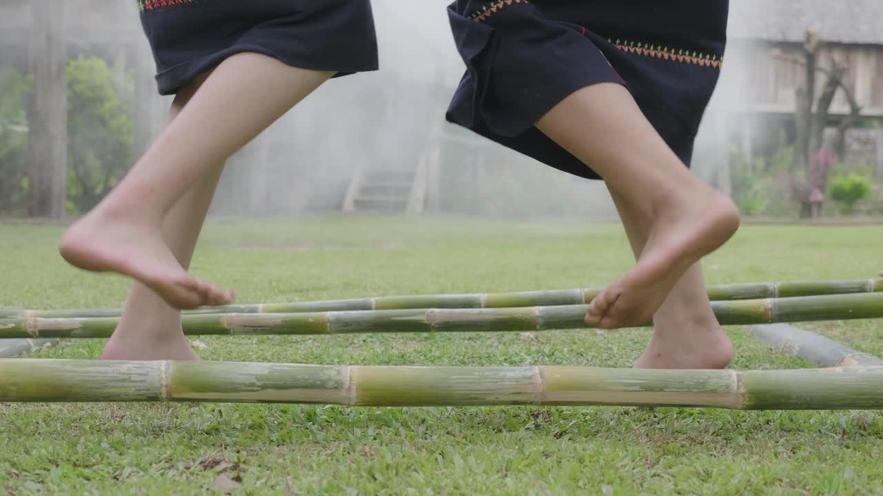 People walking on bamboo in traditional clothing