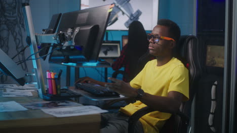 Young man working on computer design projects