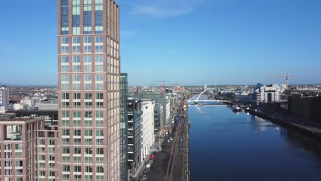 Aerial-panorama-of-Dublin-City-center-while-flying-over-river-Liffey-behind-Millennium-Tower-skyscraper