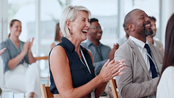 Diverse Business People Clapping and Laughing at a Conference