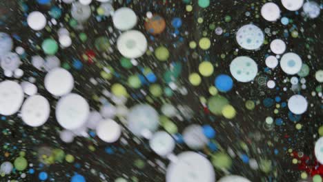 colorful bubbles. abstract yellow, blue mixture on a black background. artistic color paint background.