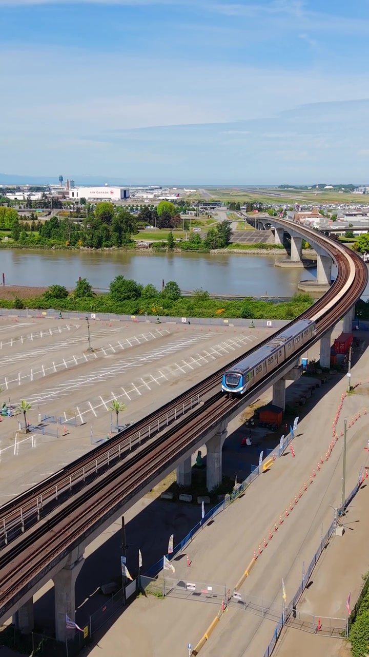 Vista Vertical do Metrô SkyTrain sobre a Ponte Middle Arm através do Rio Fraser em Richmond, Colúmbia Britânica, Canadá. Tomada Aérea.