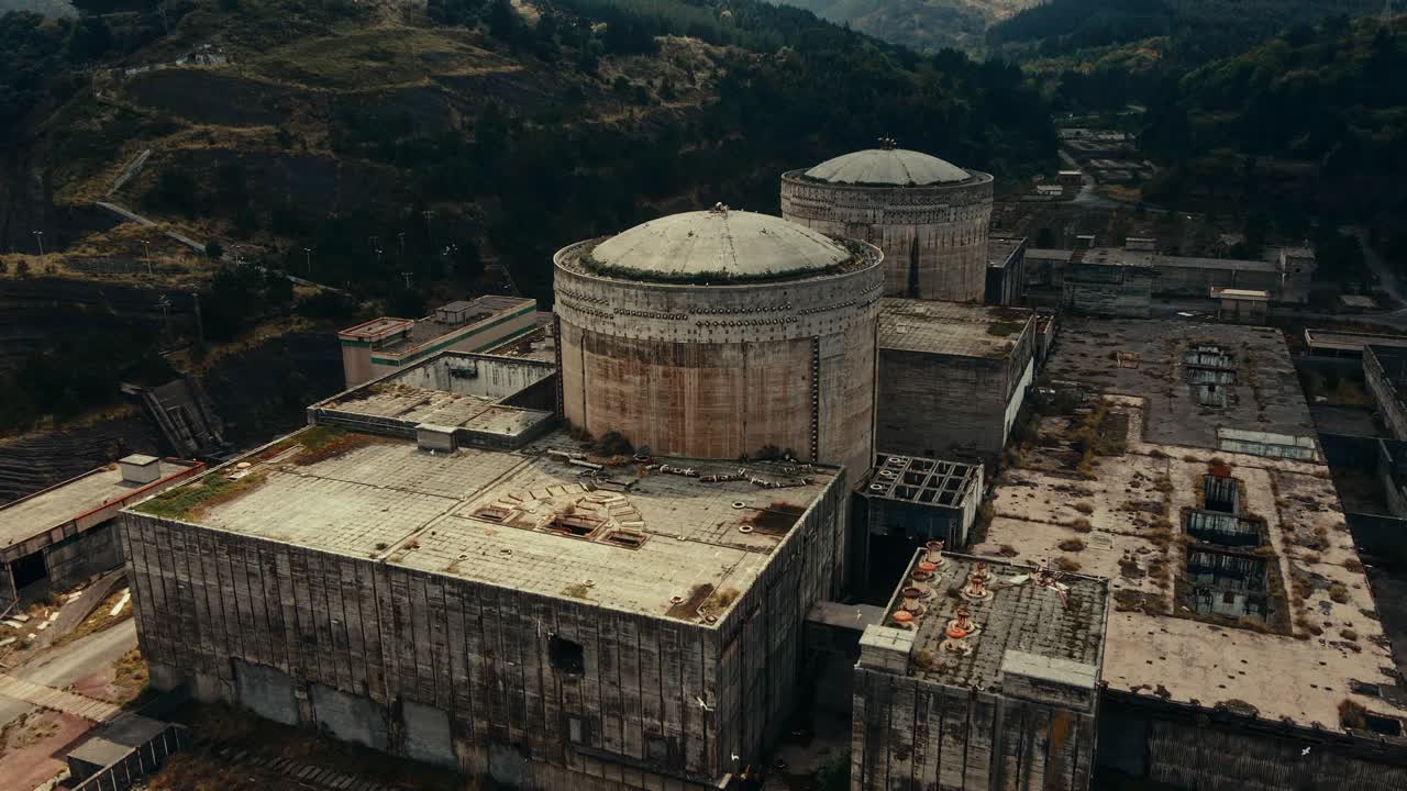 Abandoned Nuclear Power Plant with Cooling Towers in a Forested Valley