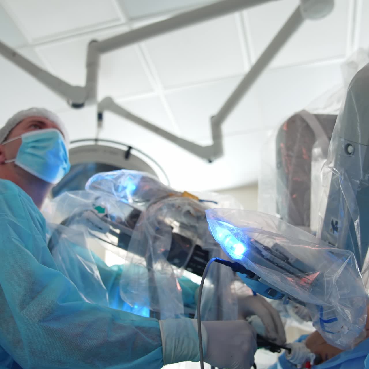 Robotic device in patient's abdomen during surgery. Doctor performs an operation using surgical robot. Medical robotic arms in patient's body. Close-up