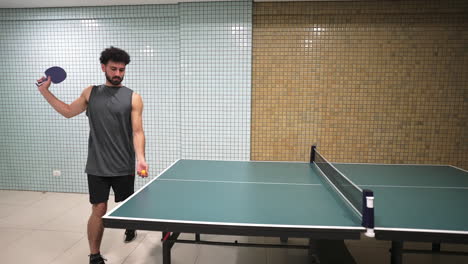 a moment of ping pong serve with the man hitting the ball across the indoor table in several times