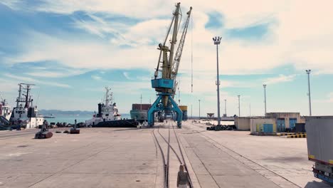 Areal-shot-of-blonde-woman-walking-in-a-cargo-area-in-a-sea-port