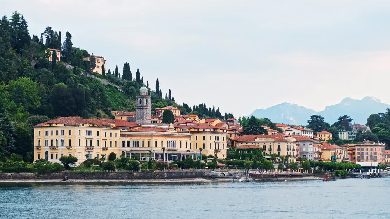 Cinematic shot of Bellagio town, Como lake and mountains from a boat in Lombardy, Italy