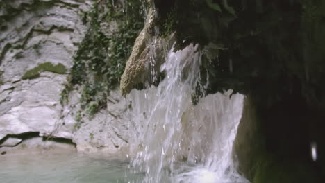 small waterfall in a rocky cave