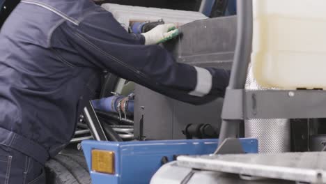 truck mechanic working on a diesel engine