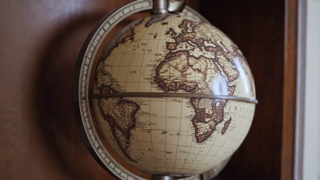 vintage globe on wooden shelf