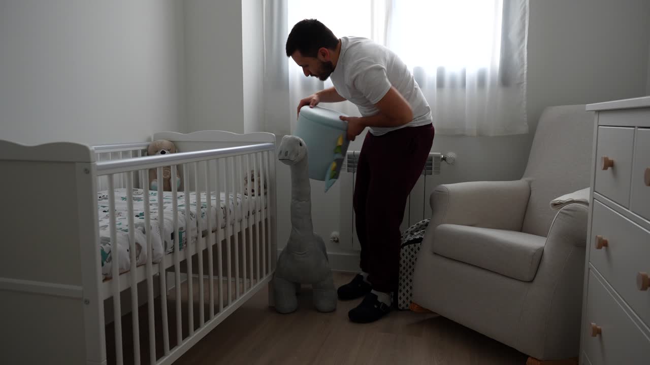 Parent organizing the baby's room by arranging the stuffed animals
