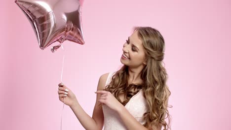 Smiling-woman-with-star-shaped-balloon-blowing-a-kiss