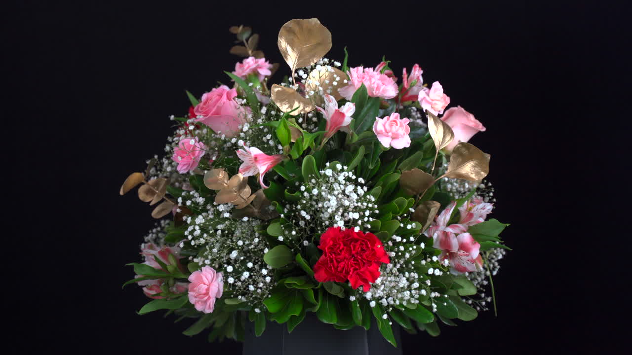 검정색 배경에서 회전하는 카네이션 배열 바구니