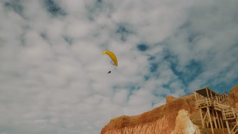 footage of paraglider sailing over cliffs in portugal