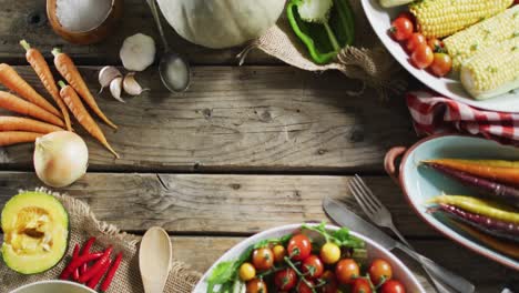 Close-up-view-of-multiple-food-ingredients-and-vegetables-on-wooden-surface