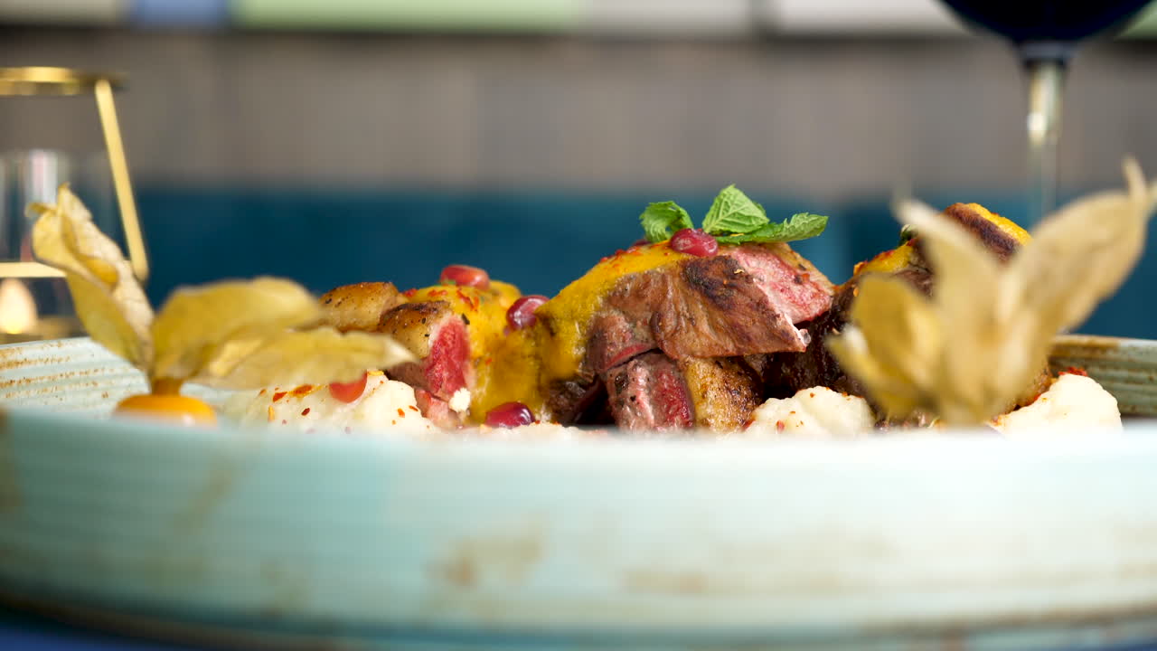 Gourmet meat dish with physalis and pomegranate