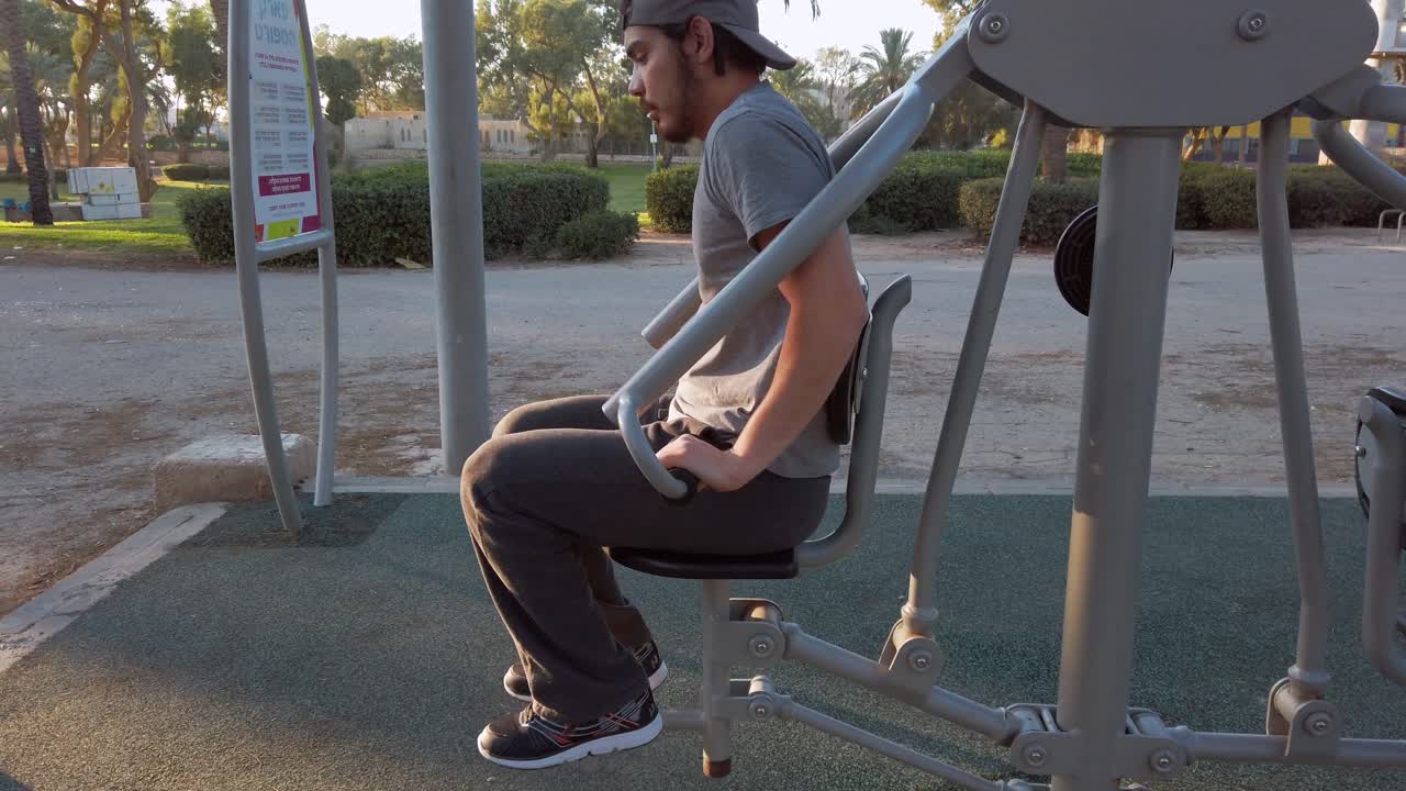 young man, lift your own weight in fitness equipment.