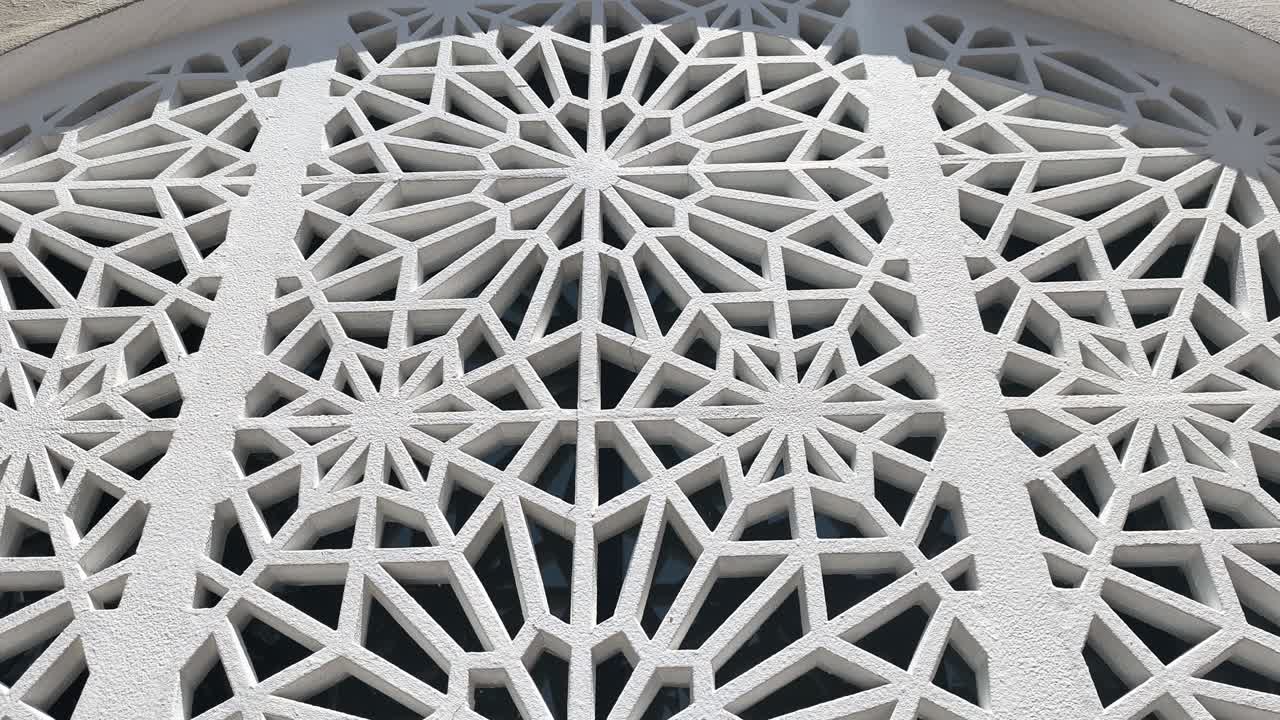 A geometric Islamic pattern crafted from GFRC forms an attractive, repeating architectural element on a wall. This decorative feature enhances the structure with traditional aesthetic design