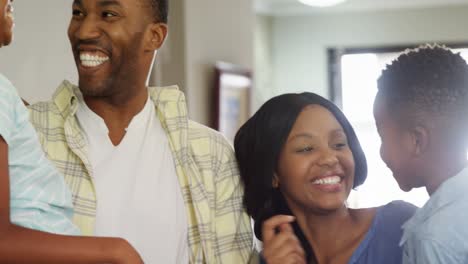 Family-standing-together-in-living-room-4k