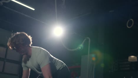 Young-man-doing-several-reps-of-deadlift-alone-in-the-gym